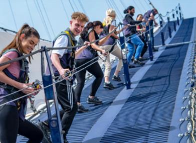A group of young people climb Up at The O2 on Greenwich Peninsula.