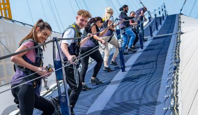 A group of young people climb Up at The O2 on Greenwich Peninsula.