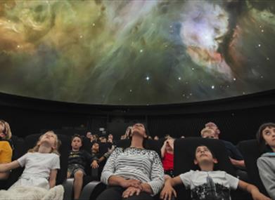 A family at the Peter Harrison Planetarium in Greenwich.