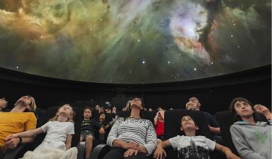 A family at the Peter Harrison Planetarium in Greenwich.