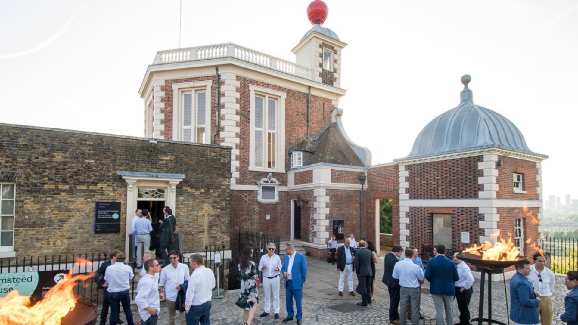A group of people gather for an event in the grounds of the Royal Observatory in Greenwich.