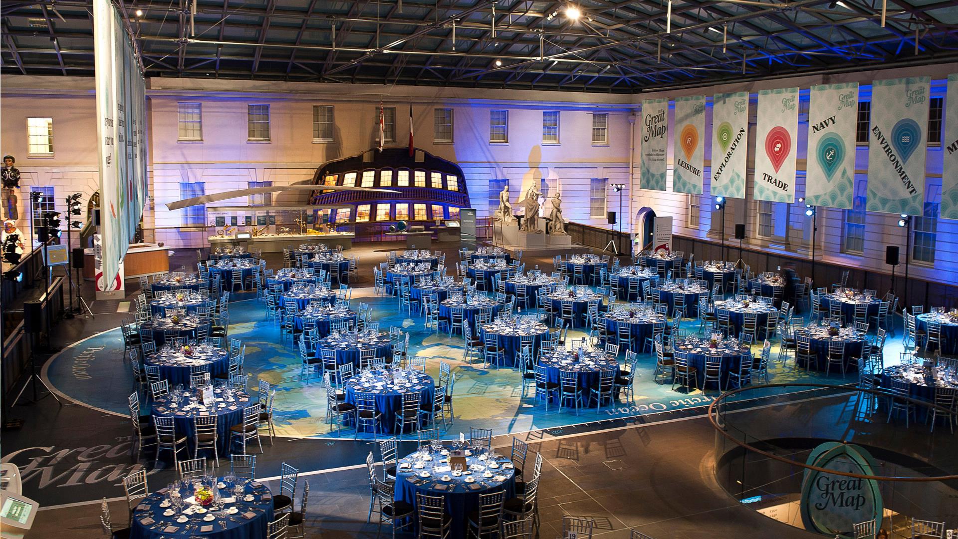 Gala dining style tables are laid out for an event at the National Maritime Museum in Greenwich.