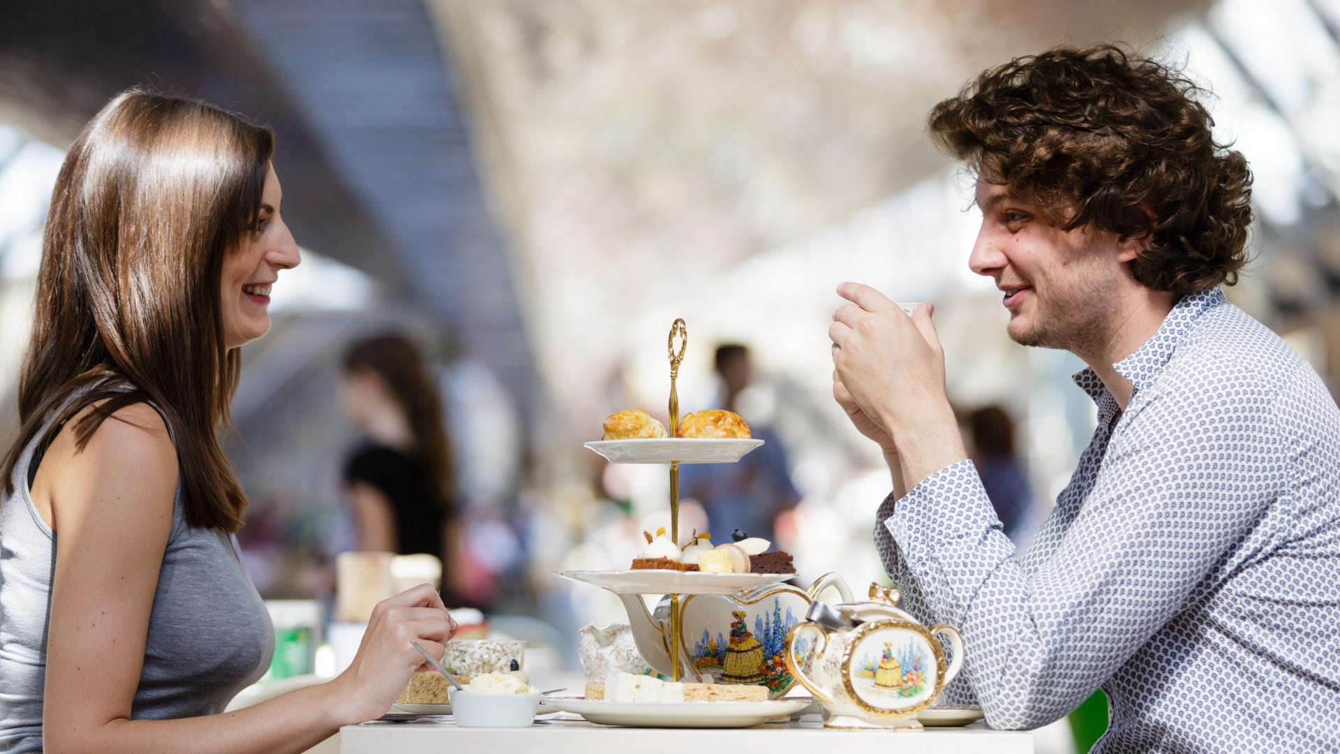 A couple have afternoon tea underneath the hull of Cutty Sark in Greenwich.