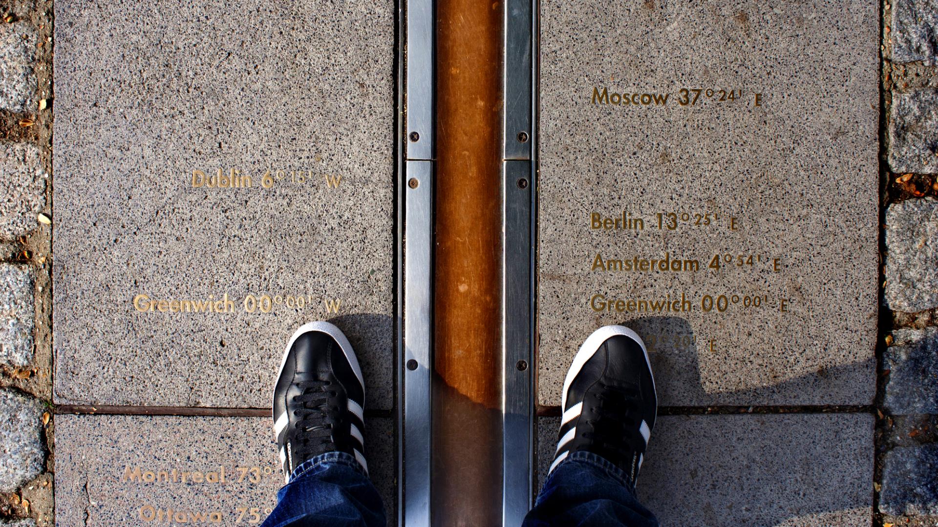 Two feet either side of the Meridian Line at historical landmark the Royal Observatory in Greenwich.