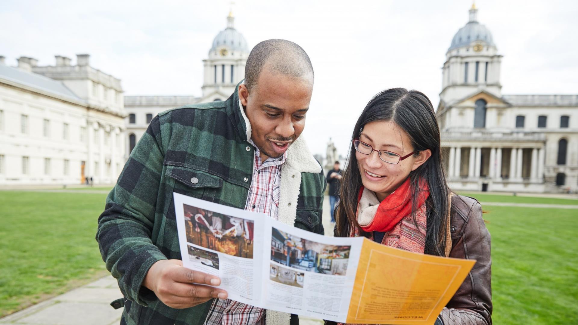 A couple look at their map and plan their trip around Good to Go locations in Greenwich.