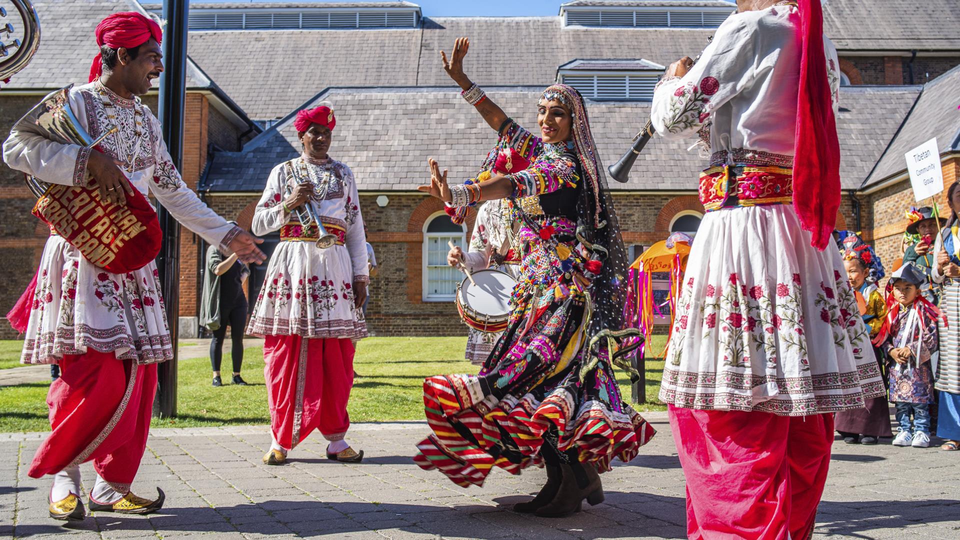 A woman dances in traditional dress at Woolwich Carnival in Greenwich.