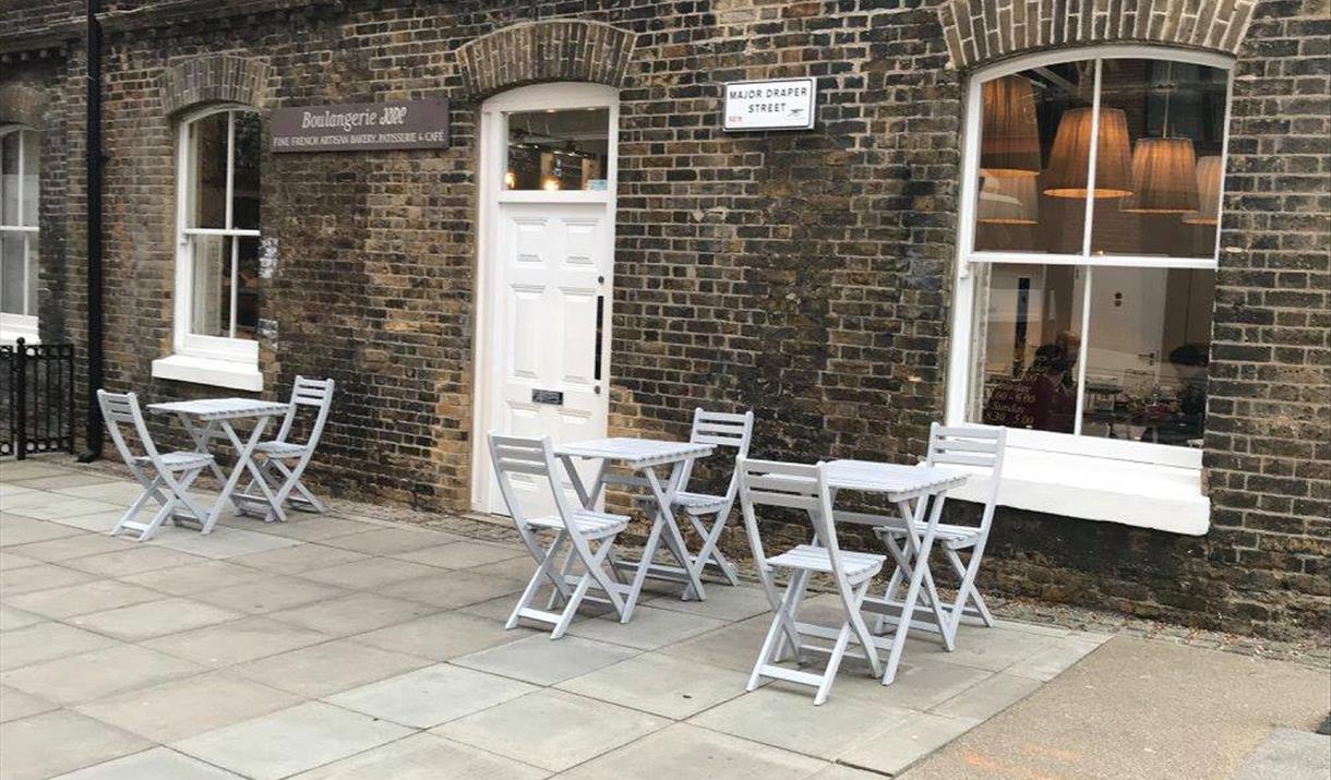 Jade Boulangerie is based in a brick finished building within the Royal Arsenal with a white entry door.  There is outside seating available as well a
