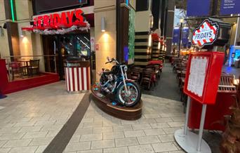 Outside TGI Fridays inside The O2. This picture shows an amazing restaurant with a motorbike featured in front and a large indoor and outdoor seating