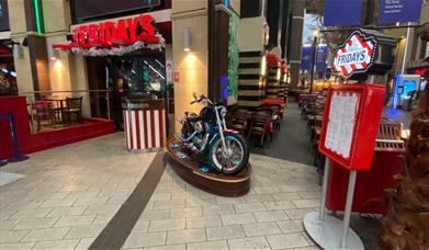 Outside TGI Fridays inside The O2. This picture shows an amazing restaurant with a motorbike featured in front and a large indoor and outdoor seating