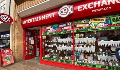 Outside CeX in Greenwich. A red shop front filled with electrical products.