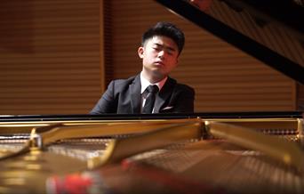 Image of pianist Aidan Chan bringing sharing a range of works from around the world