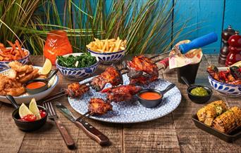 Latin American inspired cuisine with marinated meat skewers grilled fresh to order, alongside small plates of appitisers of street food with a vibrant