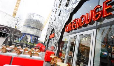 The exterior of Cafe Rouge on Greenwich Peninsula showing The O2 in the background.