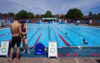 Two people prepare to get into the water at Charlton Lido in Charlton, Greenwich.