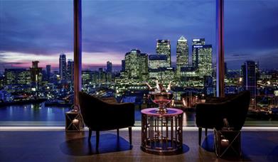 The romantic night-time view of Canary Wharf's glittering lights from Eighteen Sky Bar at InterContinental London - The O2.