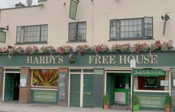 Exterior image of Hardy's Freehouse with green and beige entrance.
