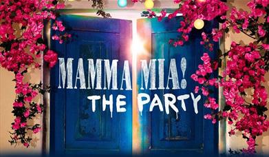 Mamma Mia! The Party entrance giving the feel of Greek island with blue wooden doors and pink flowers running across the wall