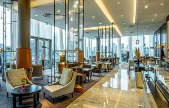 The bright and airy Meridian Lounge at InterContinental London - The O2 has stunning views through the floor to ceiling windows of the river Thames an