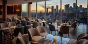 Eighteen Sky Bar overlooking the River Thames with a Sunset glow on the outside