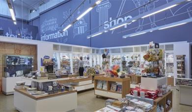 Inside the gift shop, there's a range of books, toys, ornaments and souvenirs all organized on shelves and stands.