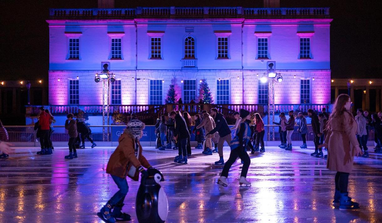 People skating at night at the Queen's House Ice Rink