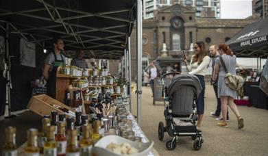 People stop to look at the range of goodies on offer at Royal Arsenal Farmers Market in Woolwich, Greenwich