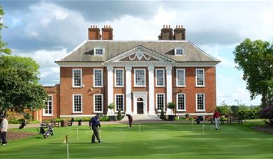 Image of Royal Blackheath Golf Club with golfers in action on the grounds.