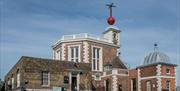 Royal Observatory and red time ball in the day with blue sky