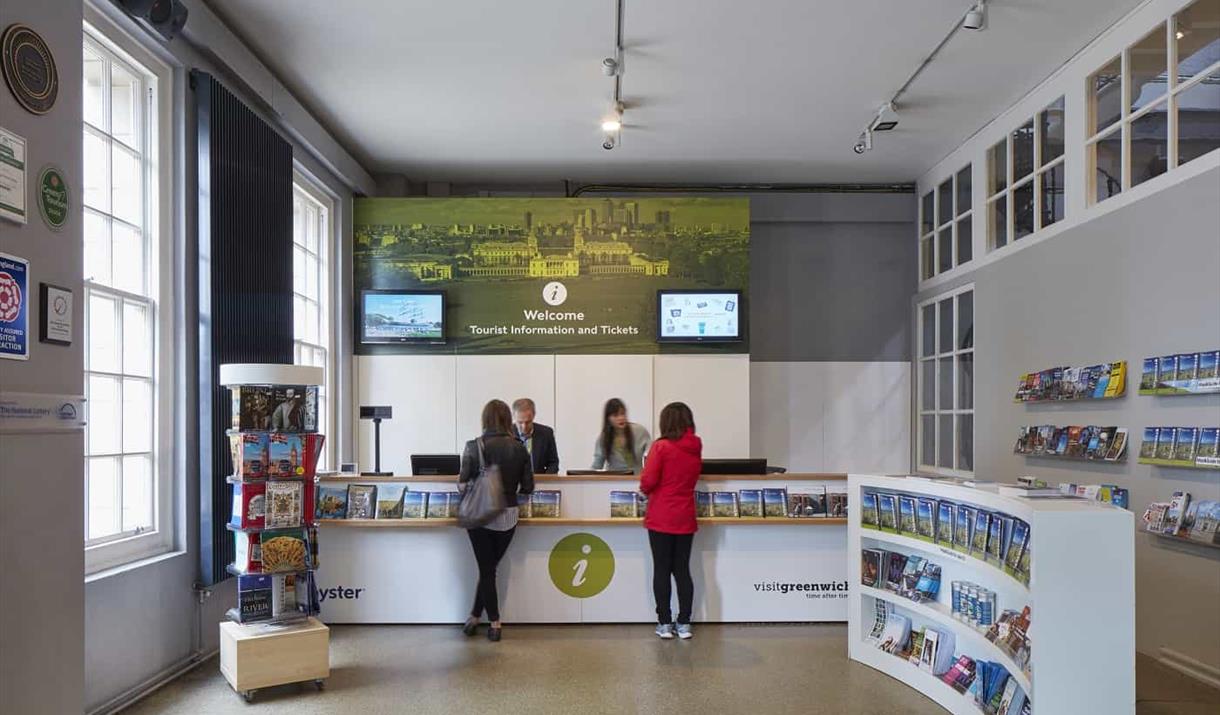 A photo of the Greenwich Tourism Centre, featuring a room filled with tourism leaflets and books. As well as an information desk.