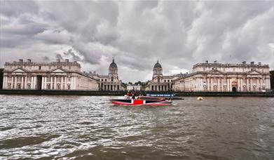 Thames Limo boat on the River Thames overlooking Old Royal Naval College