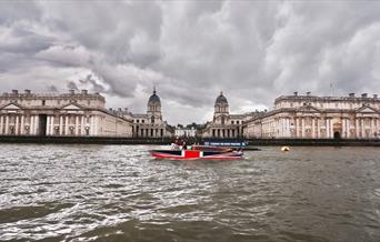 Thames Limo boat on the River Thames overlooking Old Royal Naval College