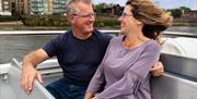 Couple enjoying a Thames River Sightseeing cruise on the River Thames