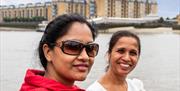 Ladies enjoying a Thames River Sightseeing cruise on the River Thames