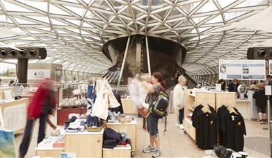 Inside The Cutty Sark Gift Shop, showing a wide range in souvenirs spread across the ground floor.