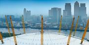 The roof of The O2 with Canary Wharf in the background