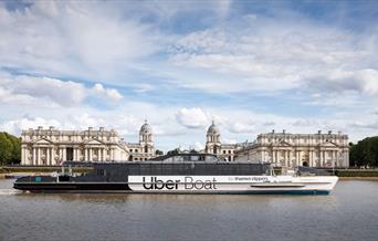 Uber Boat by Thames Clippers sailing on the River Thames overlooking the Old Royal Naval College
