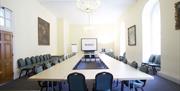 Table and chairs setup in a boardroom layout in a meeting room in the University of Greenwich