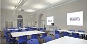Table and blue chairs setup in classroom style in a room in the University of Greenwich