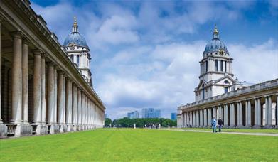 The University of Greenwich on green grass with blue sky