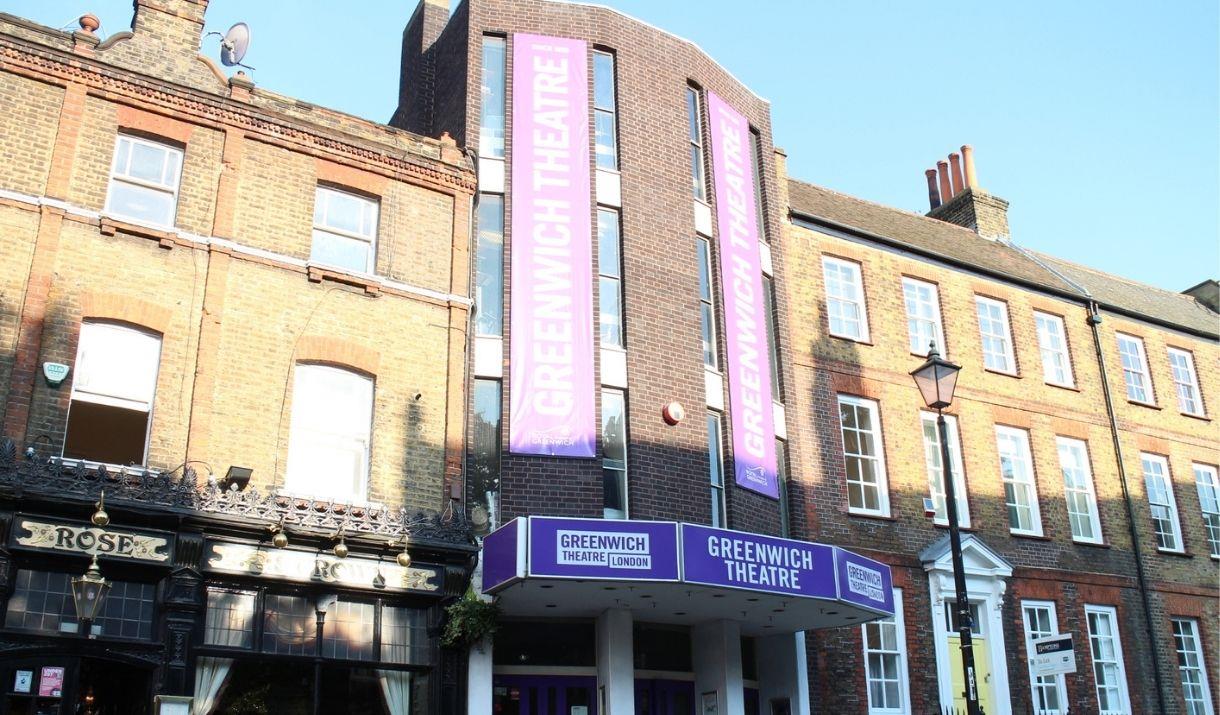 Greenwich Theatre is based in a three story brick building, with Greenwich Theatre sign in a purple background with white words going vertically up to