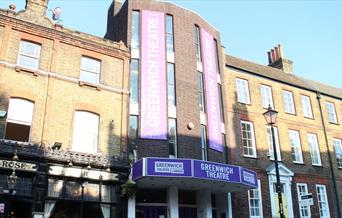 Greenwich Theatre is based in a three story brick building, with Greenwich Theatre sign in a purple background with white words going vertically up to