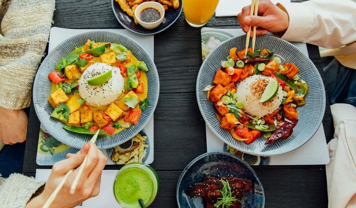 A selection of Wagamama vegan specialities including vegan ribs, chili squid, tofu firecracker and tofu raisukaree with delicious juices.
