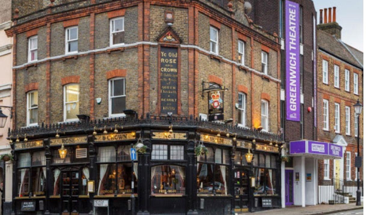 Exterior image of Ye Olde Rose and Crown pub with black window frames. The pub has Greenwich Theatre right next to it.